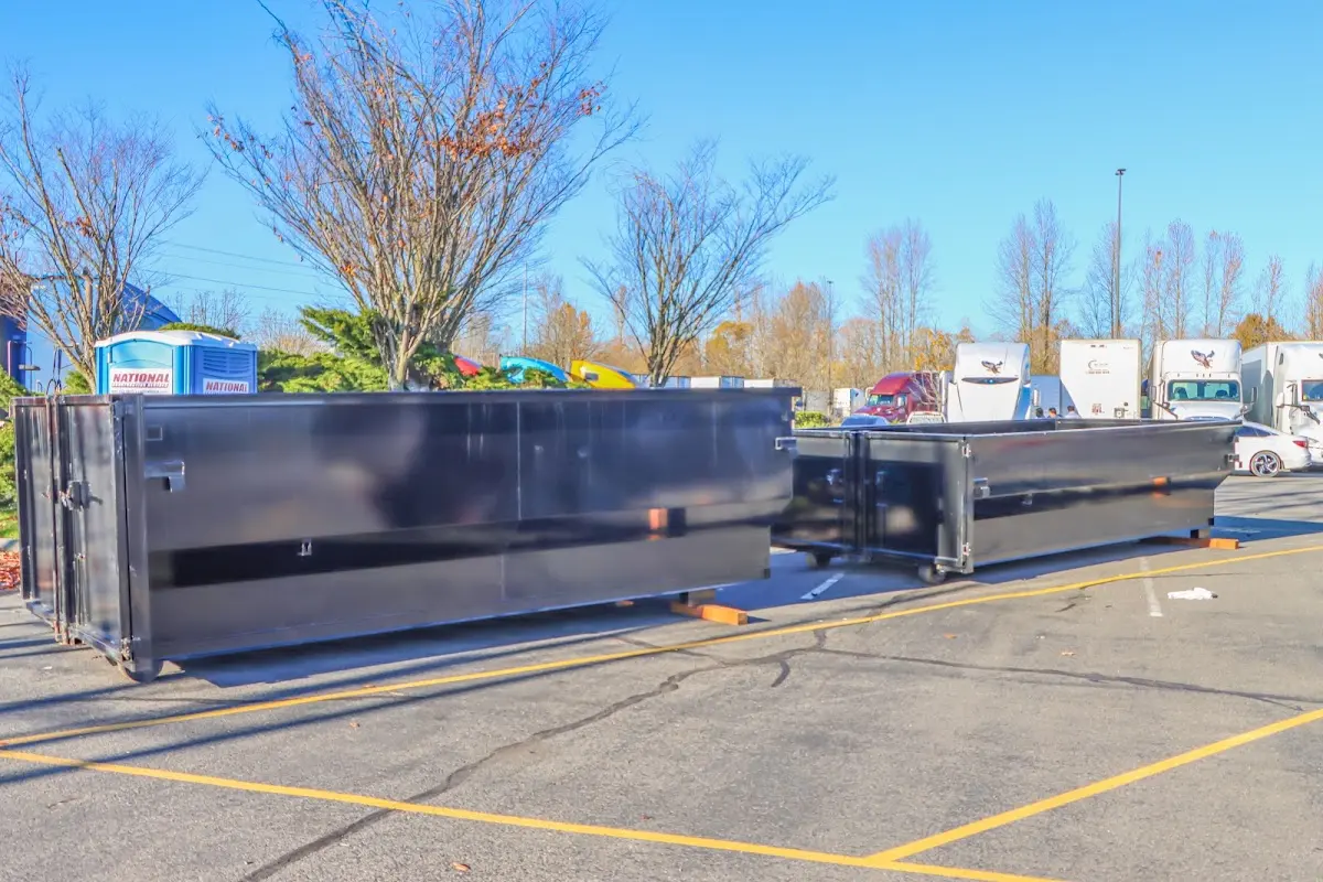 Professional dumpster rental service with roll-off container on residential driveway in Signal Hill